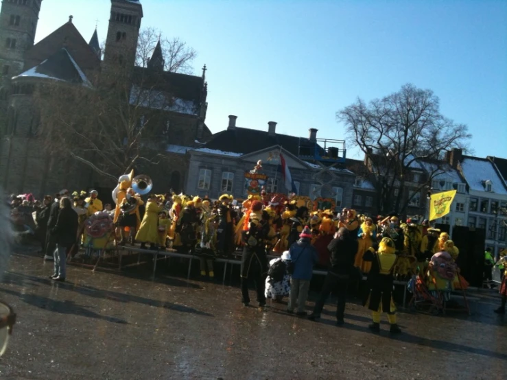 a large group of people gathered in front of buildings