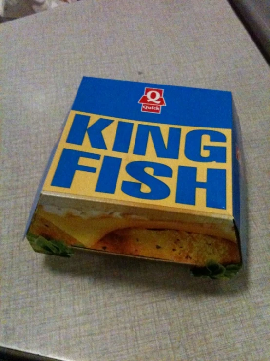 a king fish sandwich is sitting on top of a tray