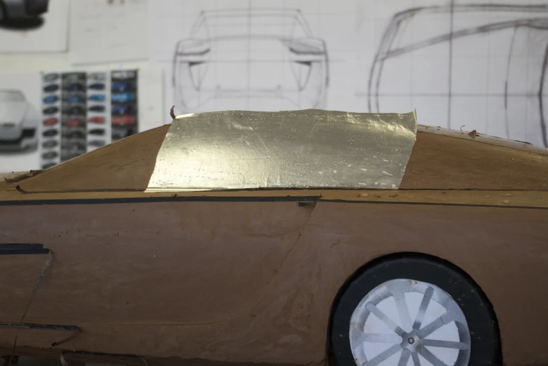 a cardboard car is covered in gold