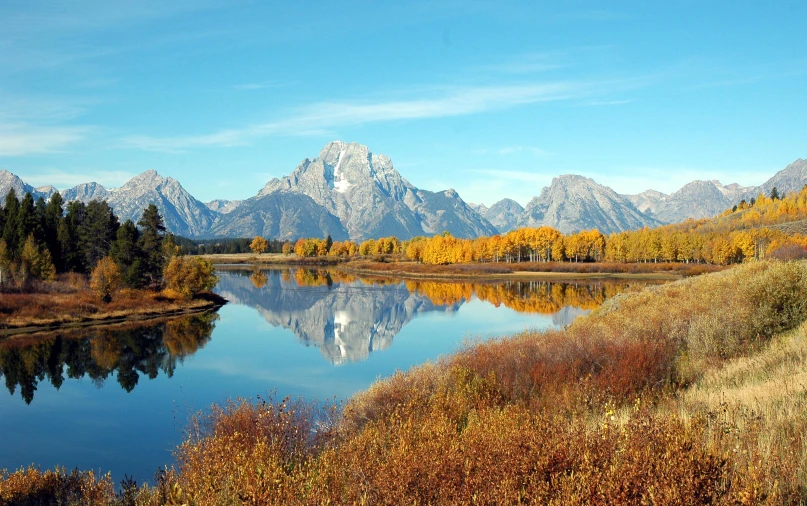 a body of water with a bunch of mountains in the background