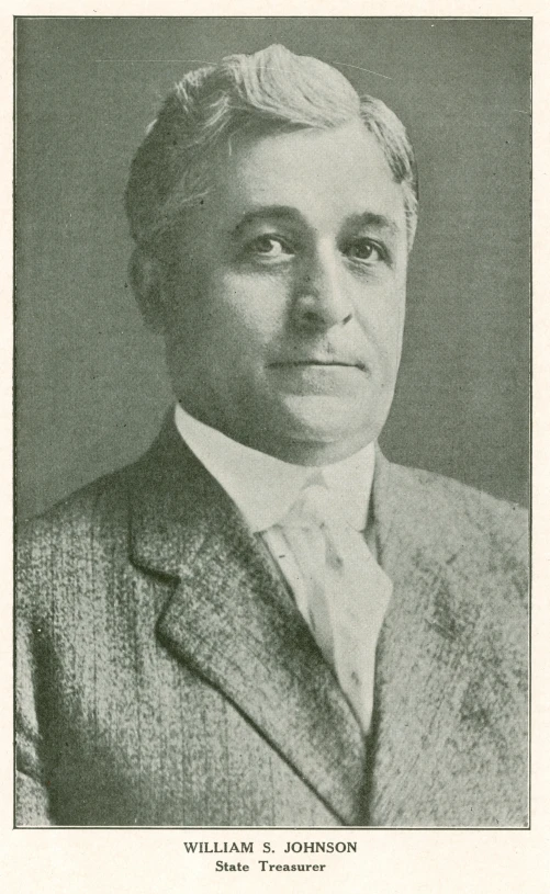 an old po of a man wearing a tie and sweater