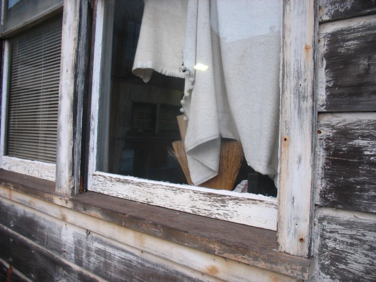 a pile of dirty kitchen towels sitting in a window