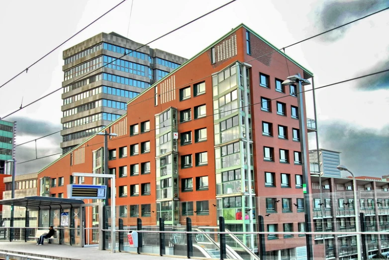 a city with lots of red buildings next to some train tracks