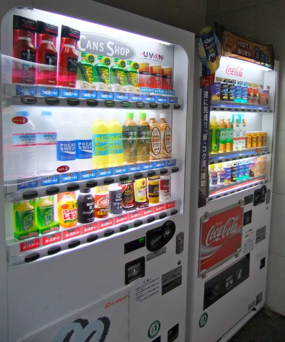 there are two vending machines side by side with sodas on each side