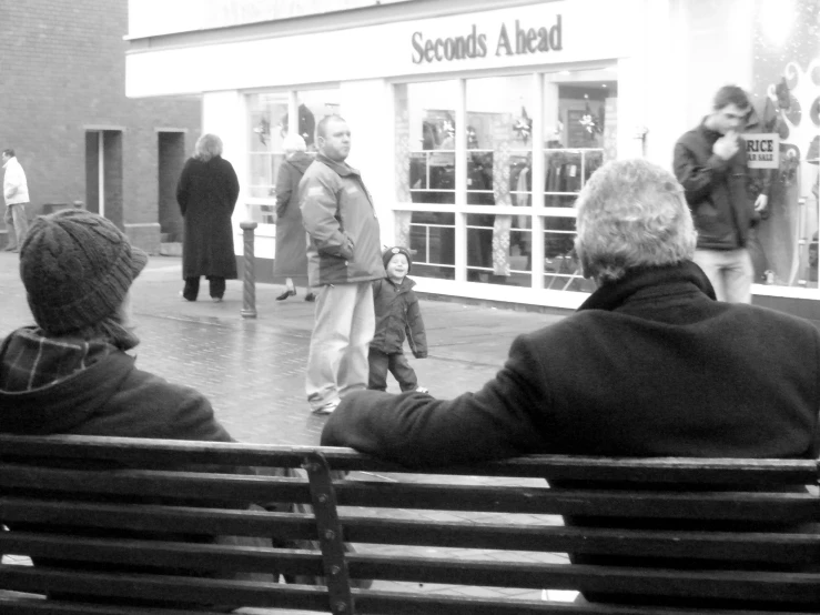 a black and white po of a man walking his dogs