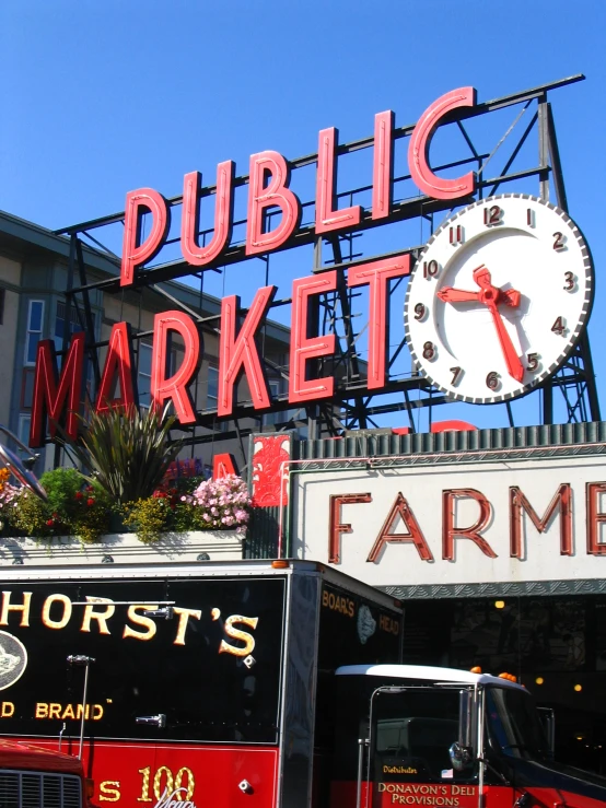 a truck is in front of the sign for a farmers market