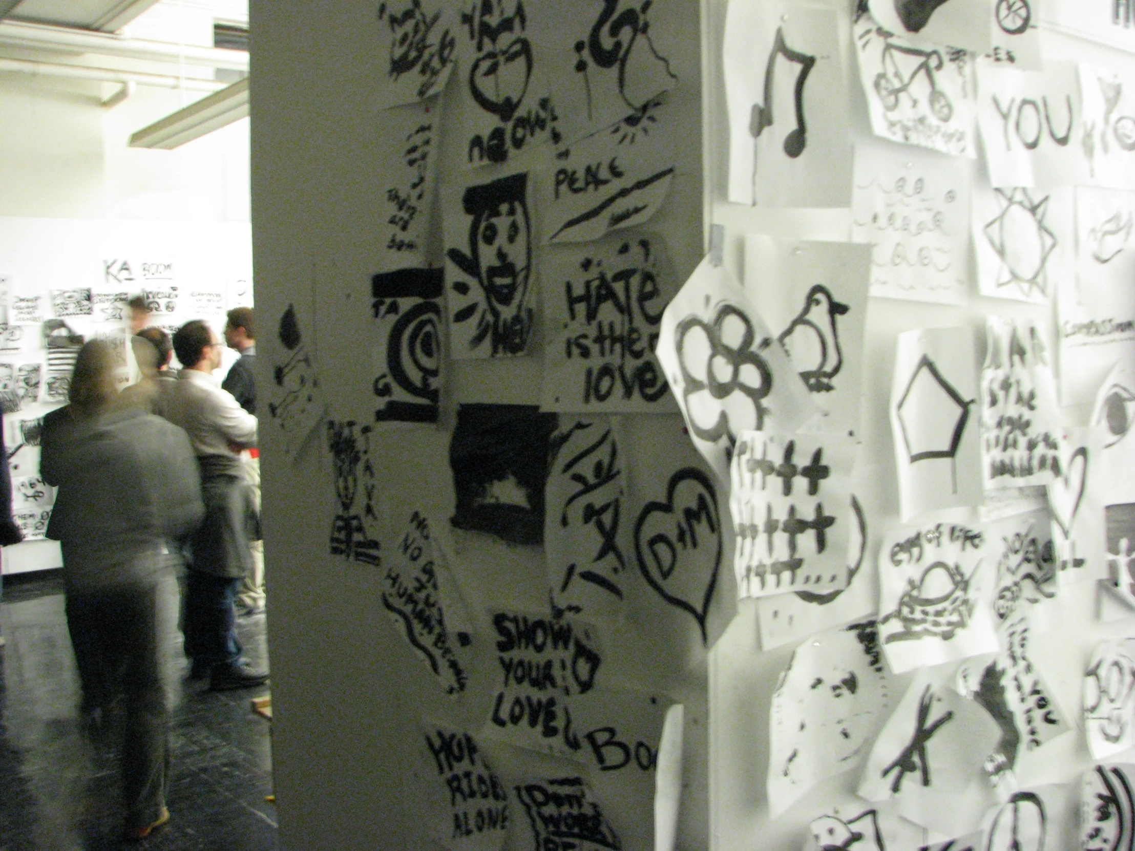 a large white and black wall covered in writing