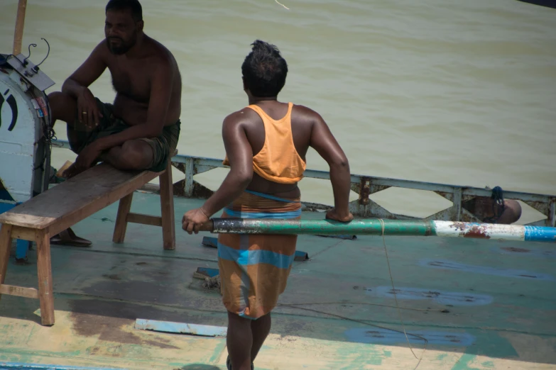 two men with a boat and life guard on the dock