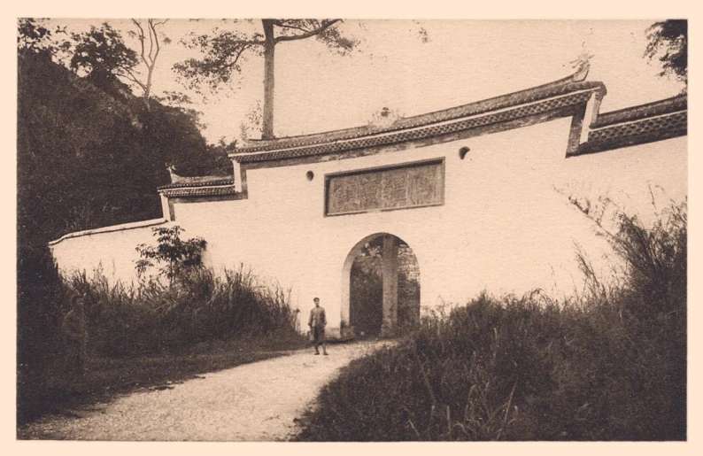 a woman in a dress stands outside of a building