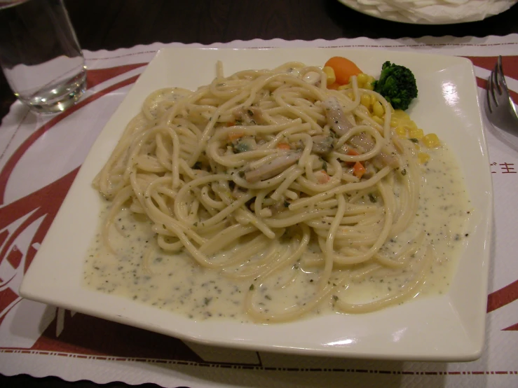 some pasta with white sauce on a plate