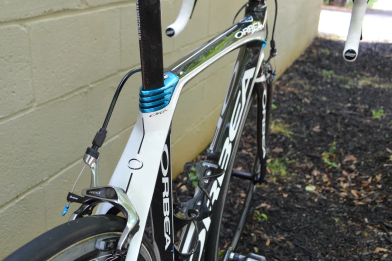 a bike is attached to a fence on the side of a house