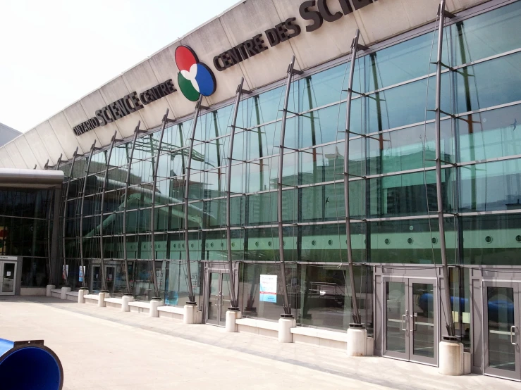 the entrance to an airport with glass walls