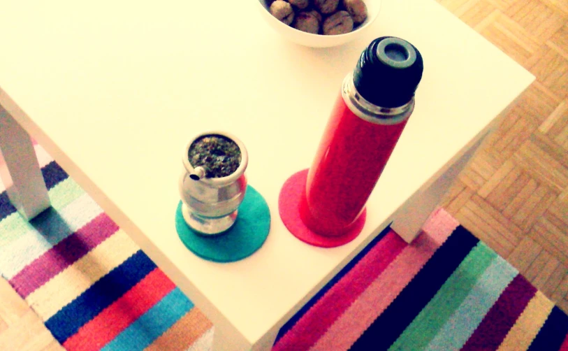 the table is decorated with a colorful striped area rug