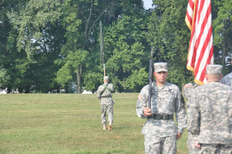 two soldiers are carrying flags in the park