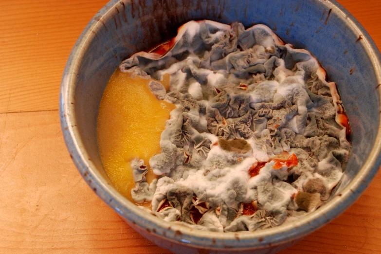 a blue bowl filled with soing yellow and white