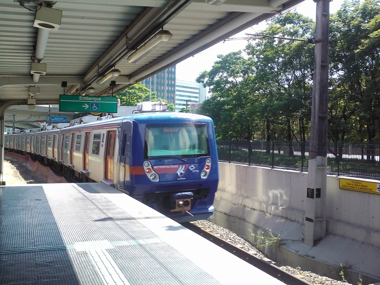 a passenger train parked at an outdoor station