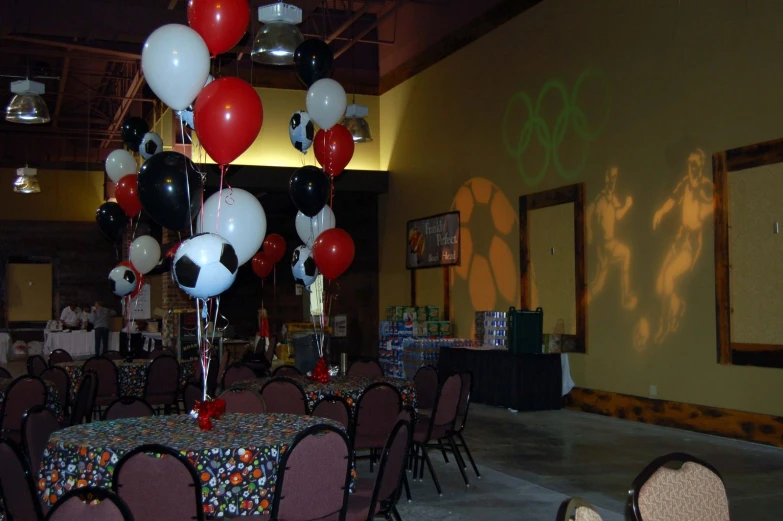 a large banquet hall with balloon decorations on tables and chairs