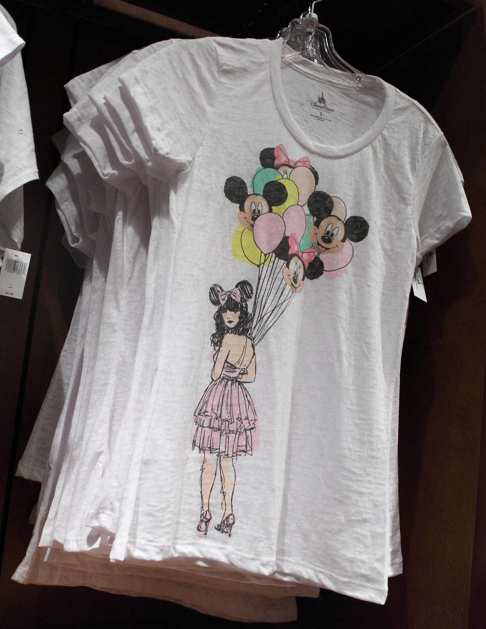 a shirt with a cartoon character holding balloons in the air
