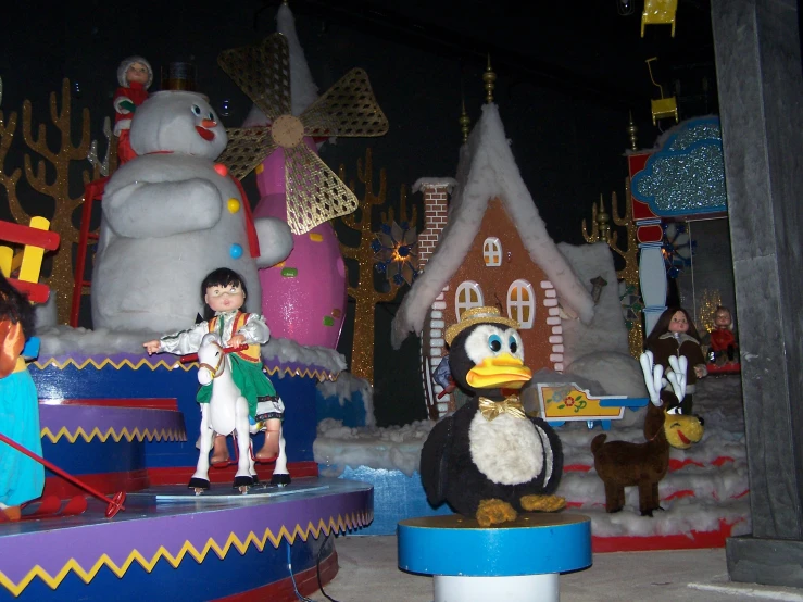 a group of toy people stand in front of the holiday decorations