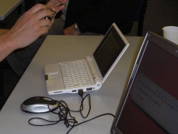 a white laptop computer sitting on top of a table