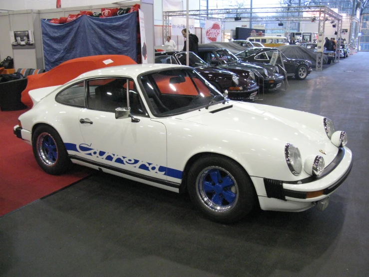 the white porsche that is on display in a showroom