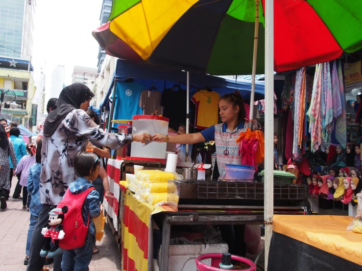 an outdoor market with many items and people