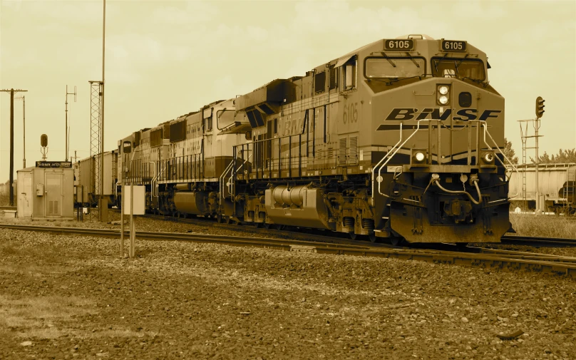 a train on the railroad tracks near some poles