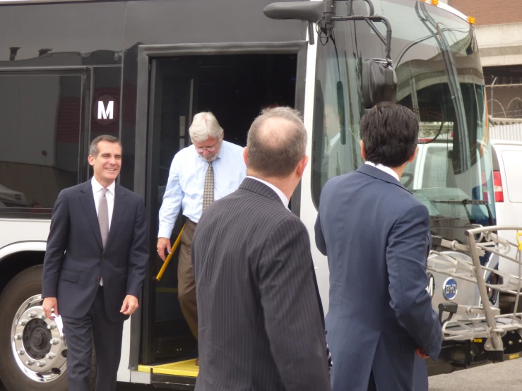 several people getting off a bus and walking