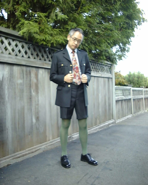 a man in black suit and green socks