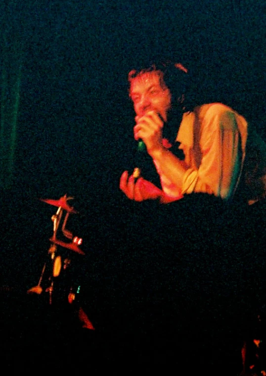 a man that is holding a microphone and singing