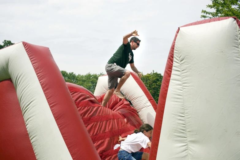 people in an event with large inflated objects and giant inflated pillows