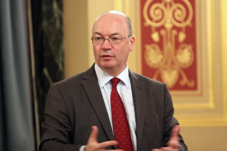 the man is wearing glasses and a tie