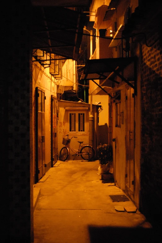 an alley way with lots of bikes parked at the end