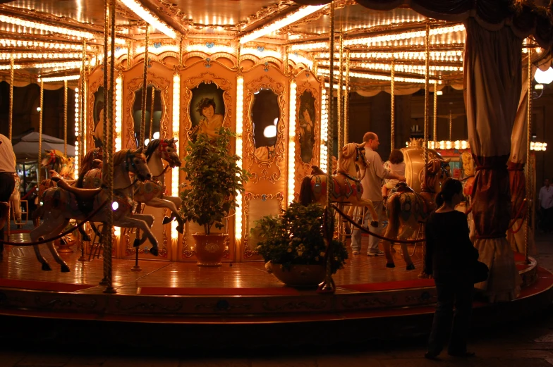 a carousel with people riding it and lights