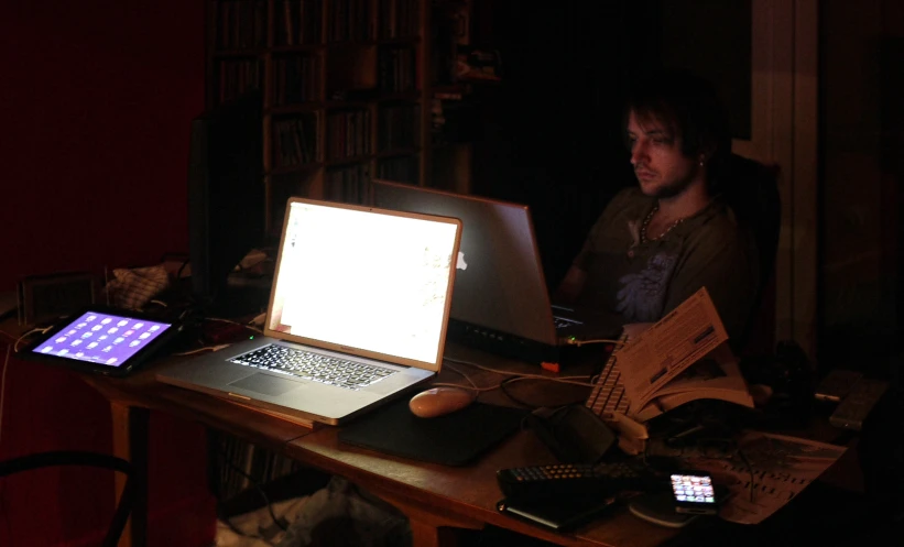 a man working on a laptop computer in his room