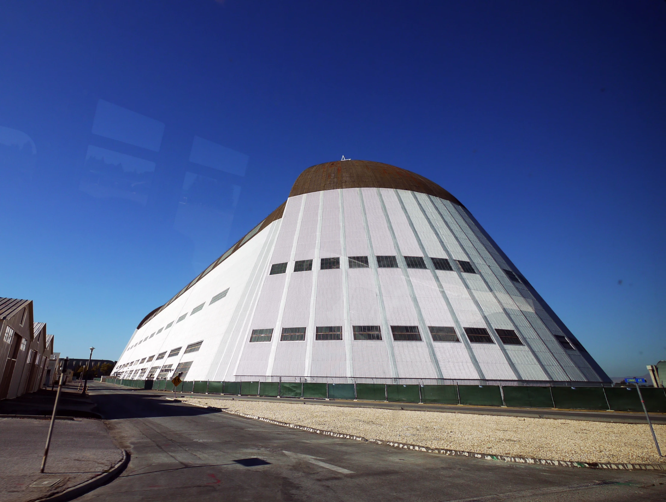 a large white building is shown in the distance