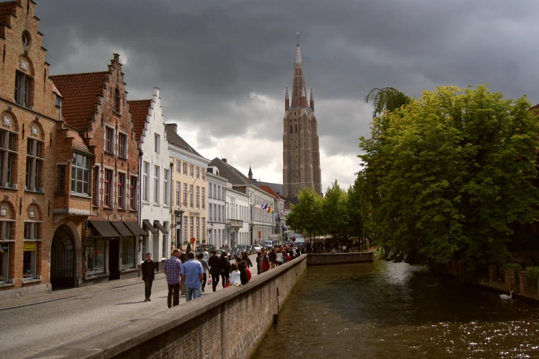 people walking along the street next to river