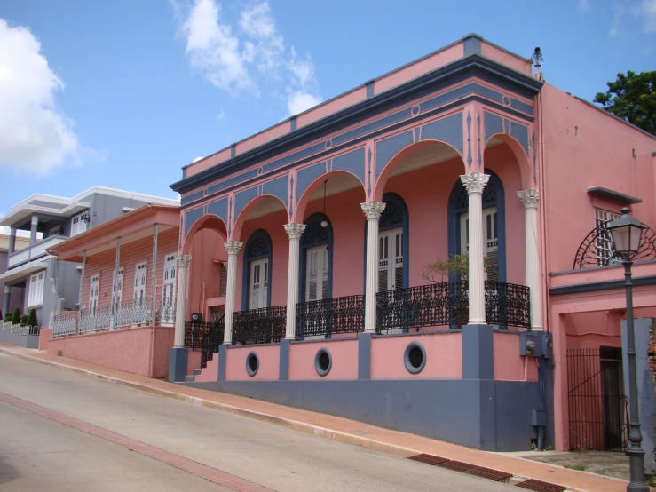 a pink building with blue and white architecture