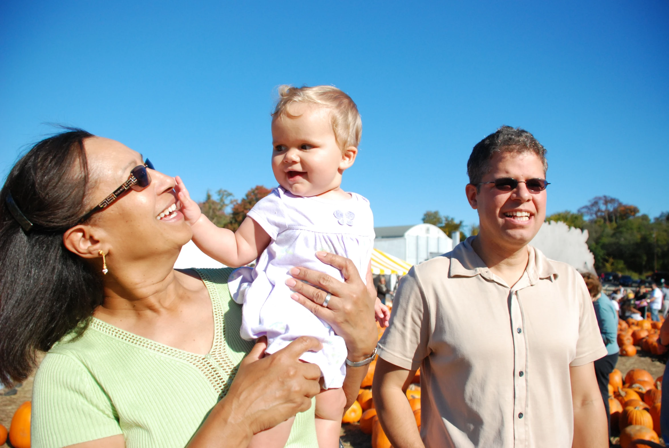 a man and a woman are holding a baby