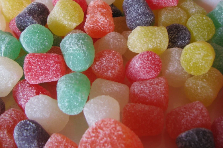 many small and colorful candies on a plate