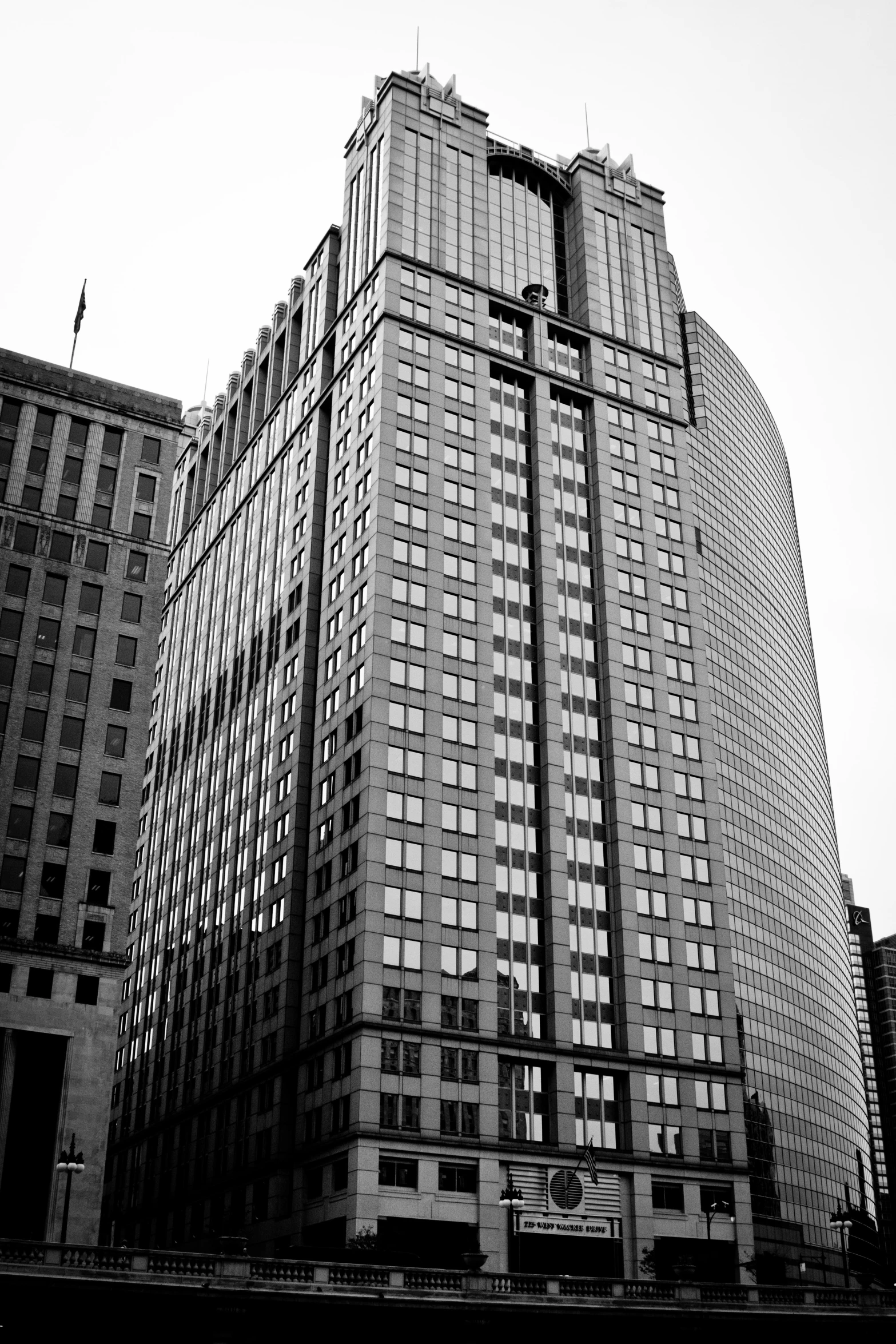 two very tall buildings with tall windows in the sky