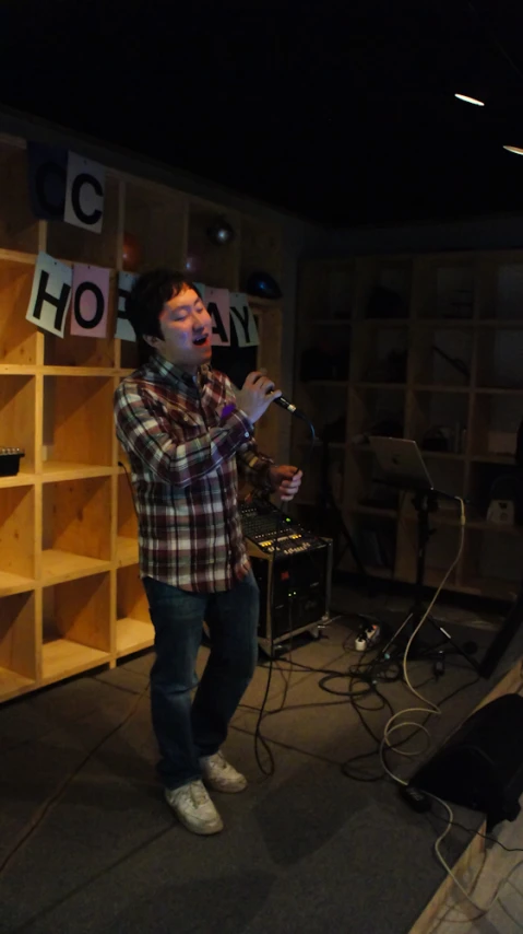 a man on a mic in a recording studio