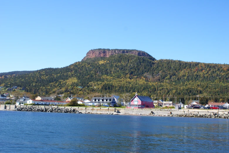 the small town has large mountains in the background