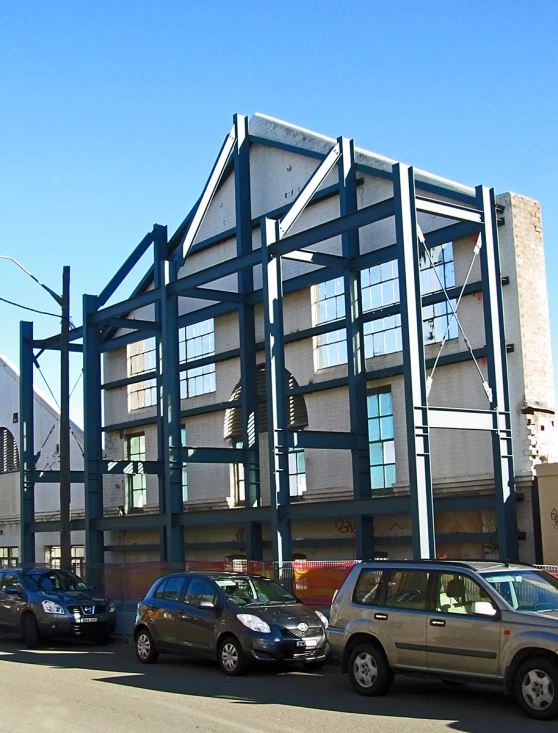 several cars are parked in front of an industrial building