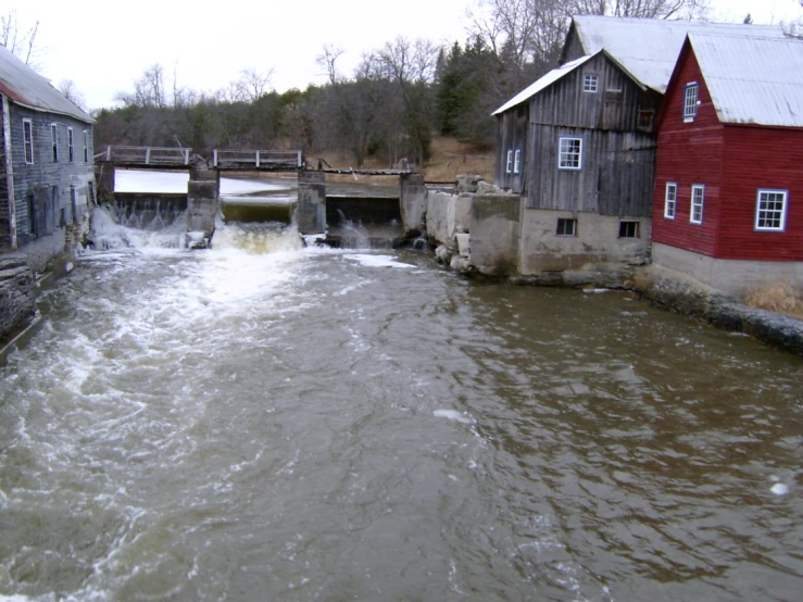 the water is moving past the large red houses