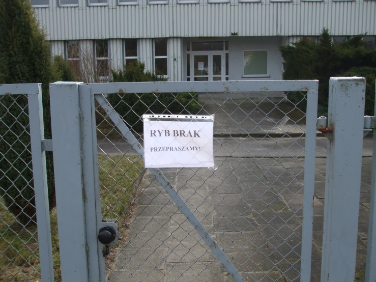 a fenced off area with an advertisment for parking near by