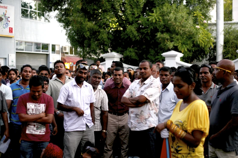 a crowd of people standing next to each other