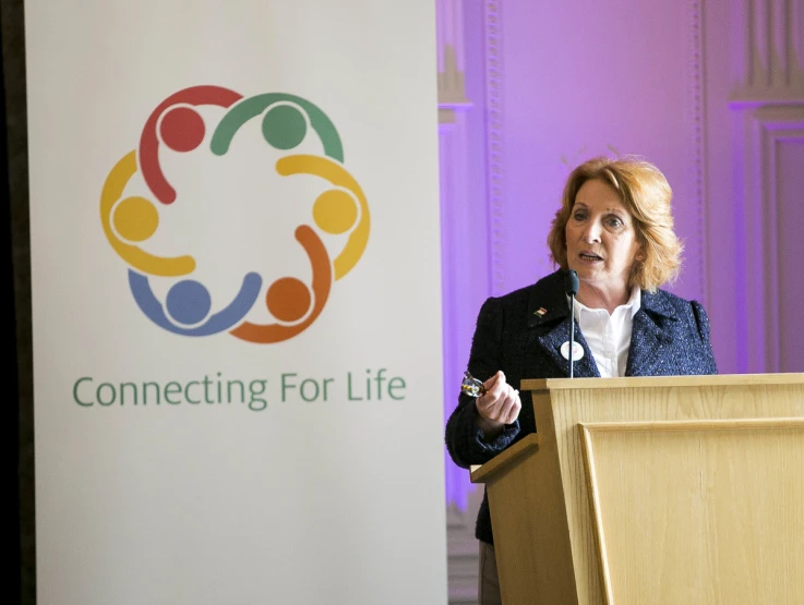 a woman is giving a speech with her hands