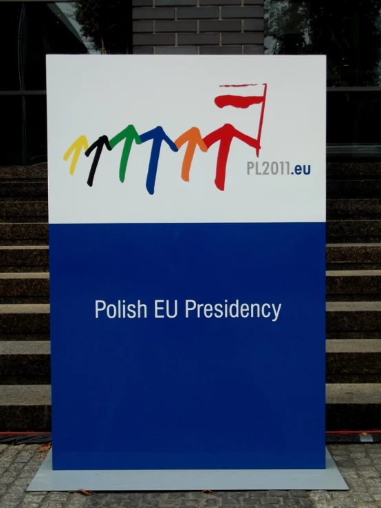 a polish eu sign in front of some steps