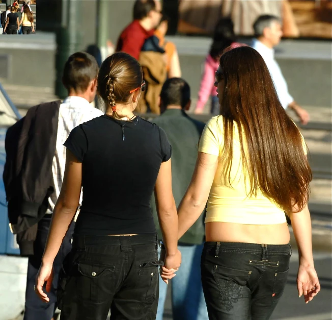two females walking together down the street